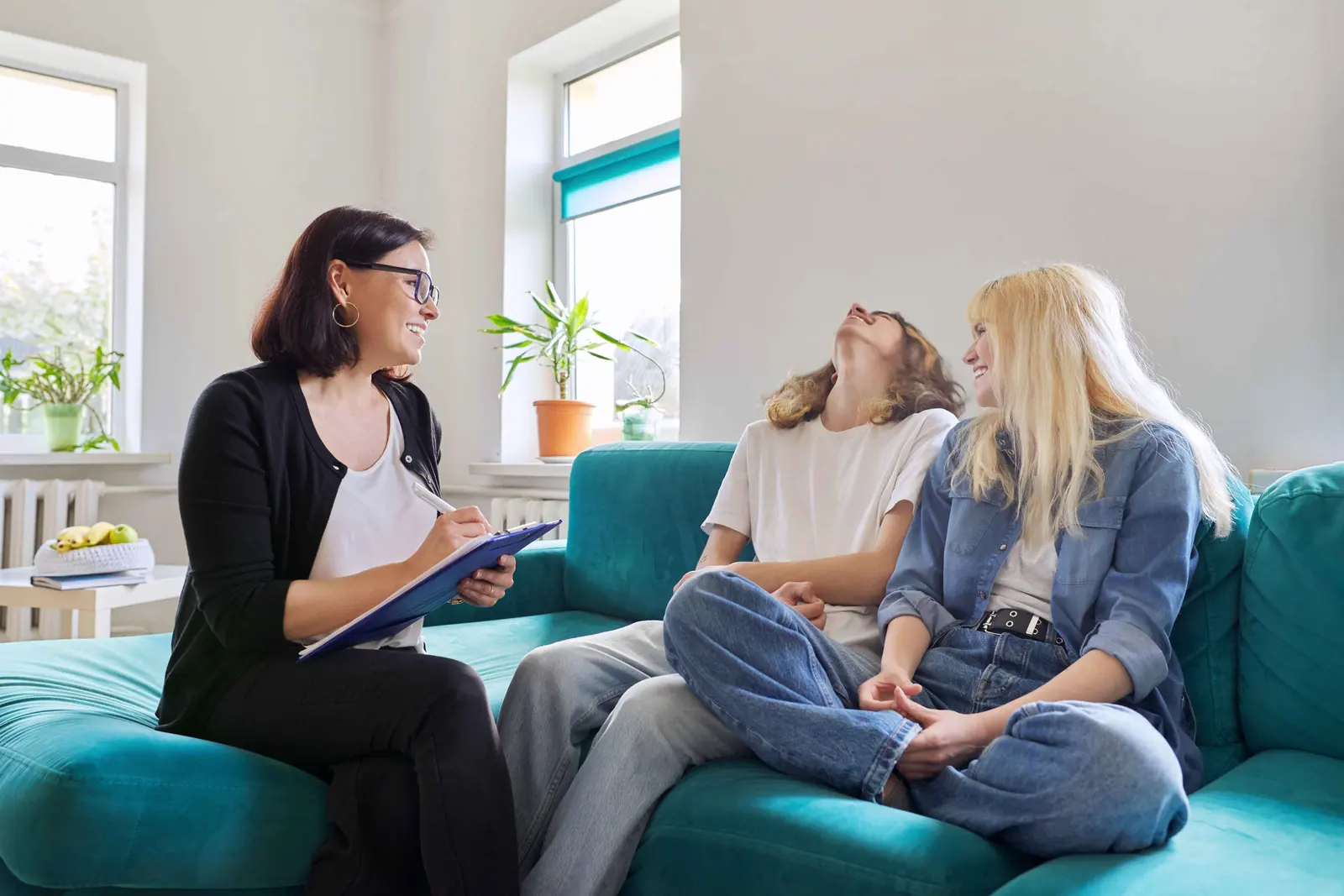 A social worker sitting with a family, talking something through