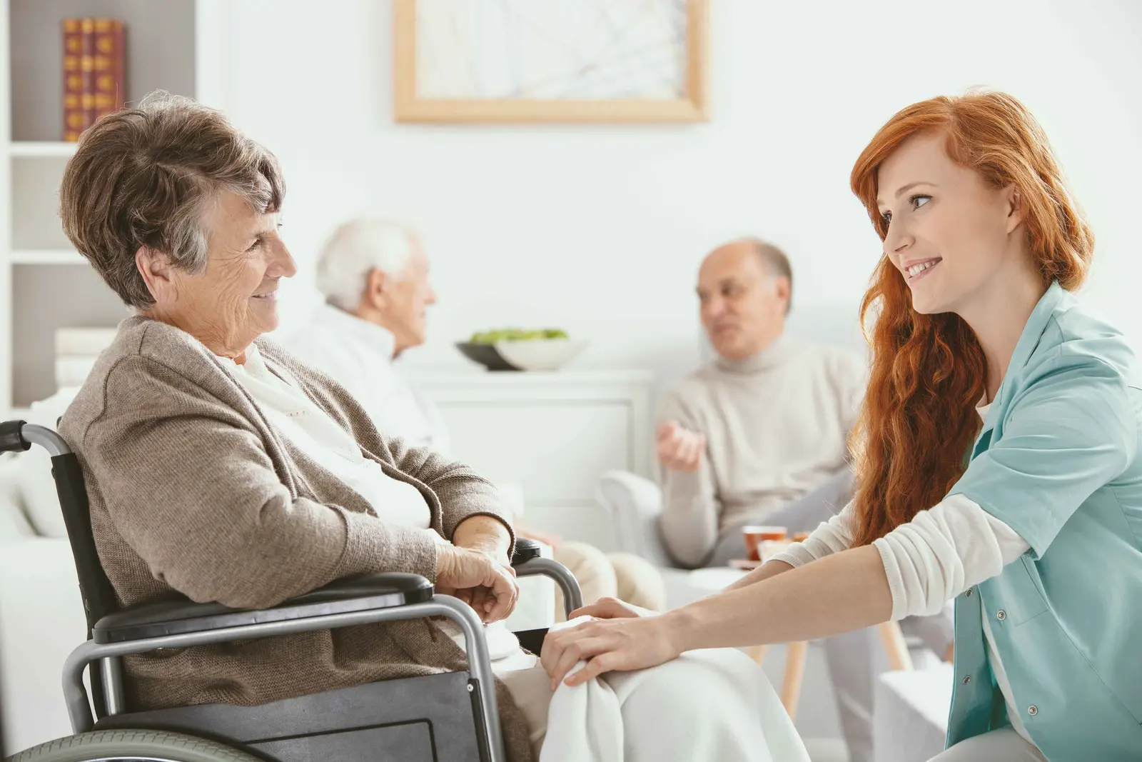 A hospice nurse listening to a patient during a home visit